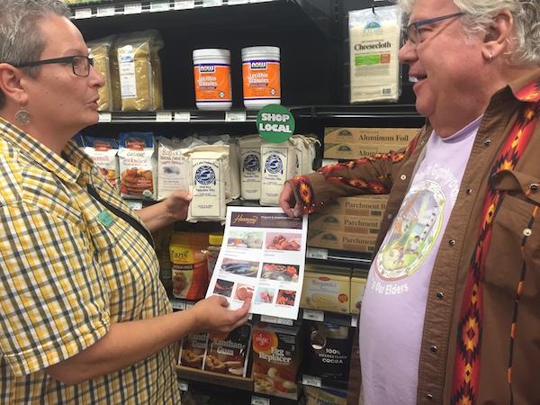 GM Colleen Bakken shows shopper Objibwe shopping guide