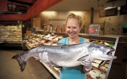 a picture of a woman holding a fish