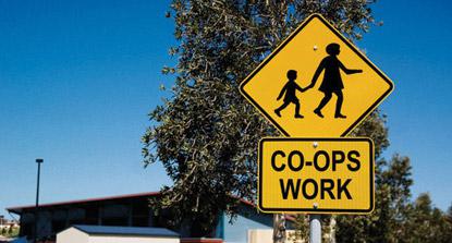 street sign with image of mom holding childs hand