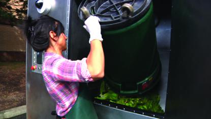 Woman dumping food scraps into bin