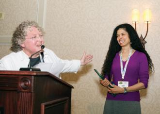 Rochelle Prunty, general manager of River Valley Market Co-op, presenting the Cooperative Board Serivce award to Jade Barker